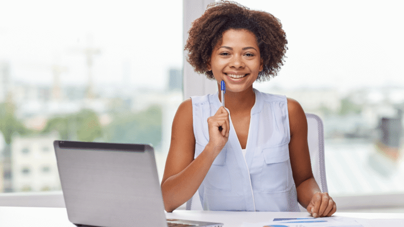 Botswana business owner working at a laptop with business documents